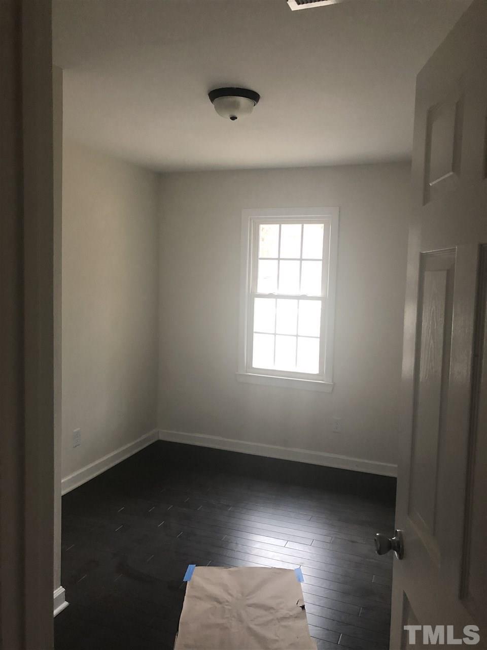 2900 Alron Road Wendell, NC 27591 - Photo 10 of 15 an empty room with wooden floor and windows