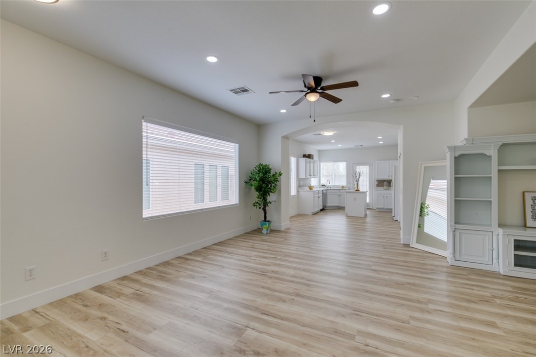 10959 Pumpkin Ridge Avenue Las Vegas, NV 89135 - Photo 8 of 51 Well-lit living room features an inviting open concept leading to a beautiful white kitchen.