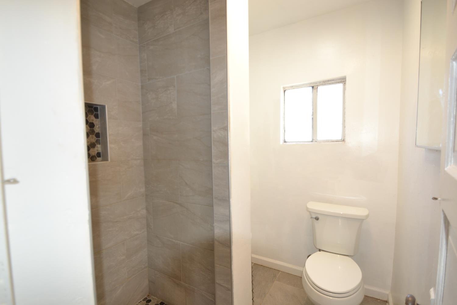 188 Justine Avenue Reedley, CA 93654 - Photo 14 of 20 a white toilet sitting next to a bathroom sink