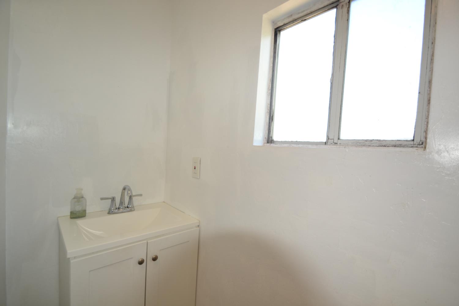 188 Justine Avenue Reedley, CA 93654 - Photo 15 of 20 a bathroom with a sink and a window