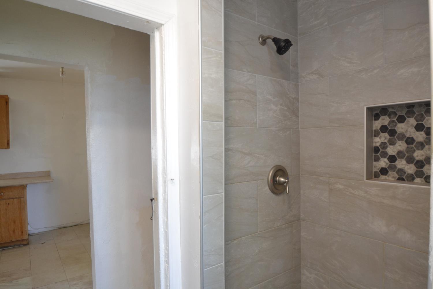 188 Justine Avenue Reedley, CA 93654 - Photo 16 of 20 a bathroom with a shower