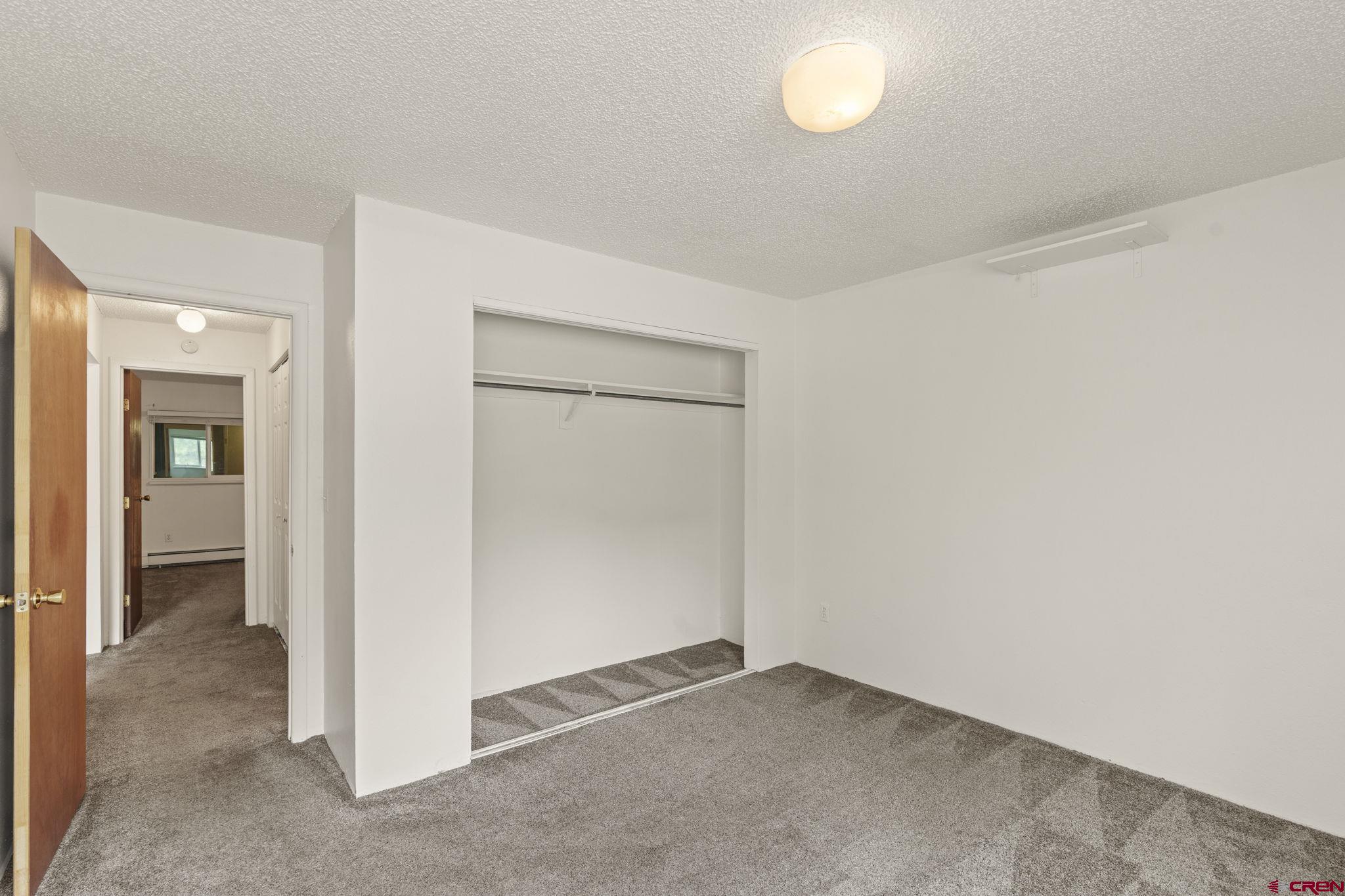 1135 Florida Road, Unit A29 Durango, CO 81301 - Photo 28 of 33 an empty room with window in back and closet area