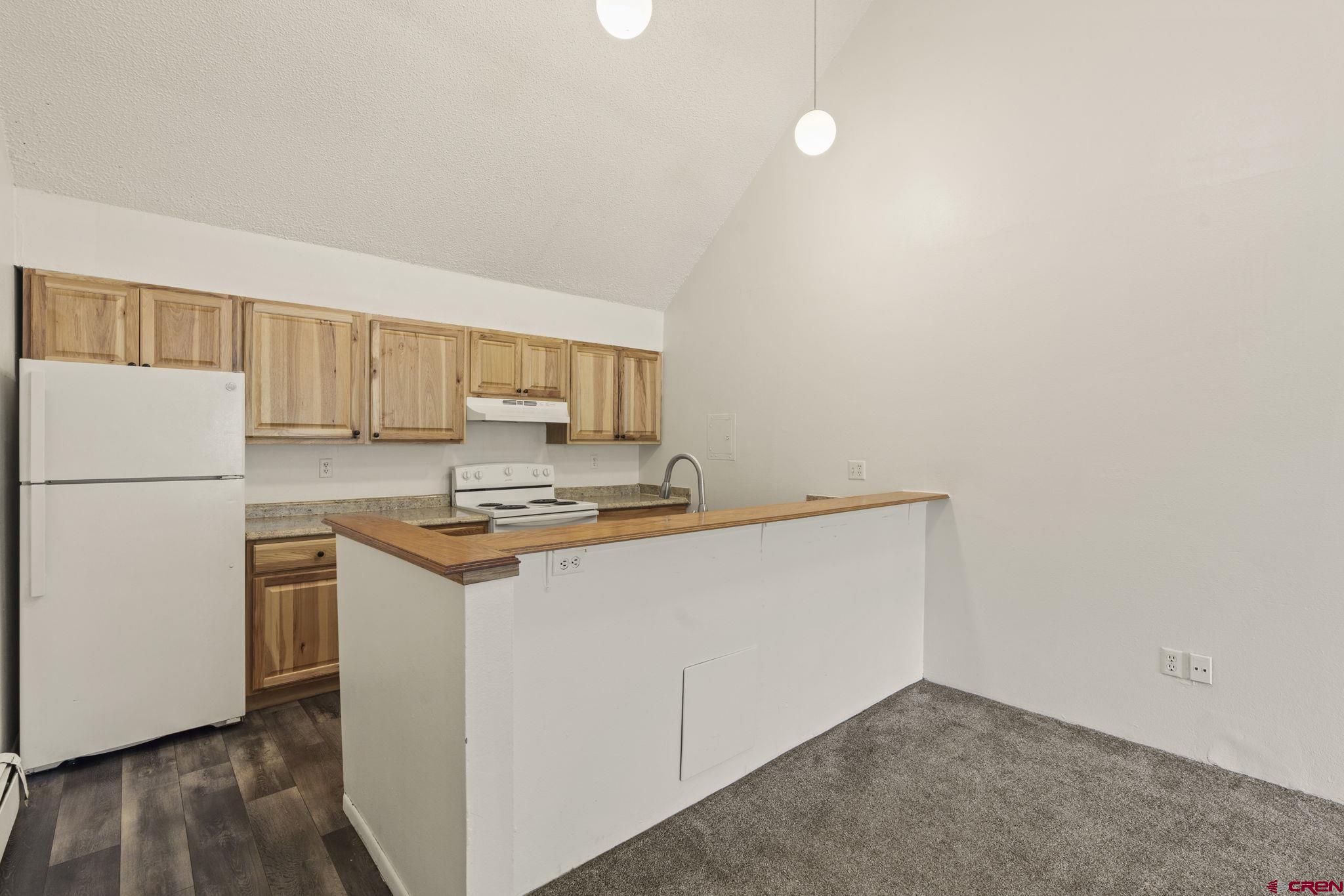 1135 Florida Road, Unit A29 Durango, CO 81301 - Photo 6 of 33 a kitchen with stainless steel appliances granite countertop a stove a refrigerator and a refrigerator
