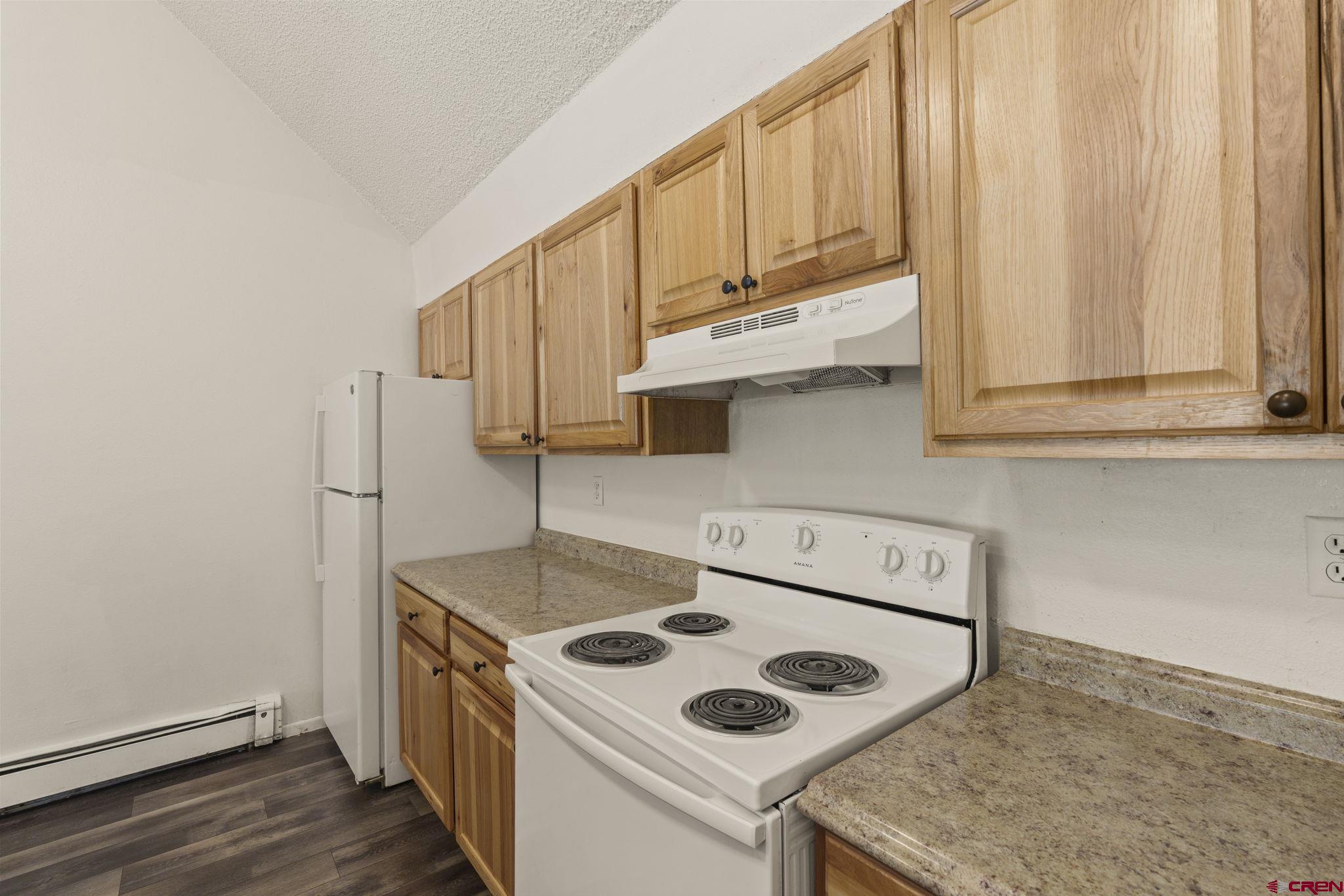 1135 Florida Road, Unit A29 Durango, CO 81301 - Photo 8 of 33 a kitchen with stainless steel appliances granite countertop a sink stove and refrigerator