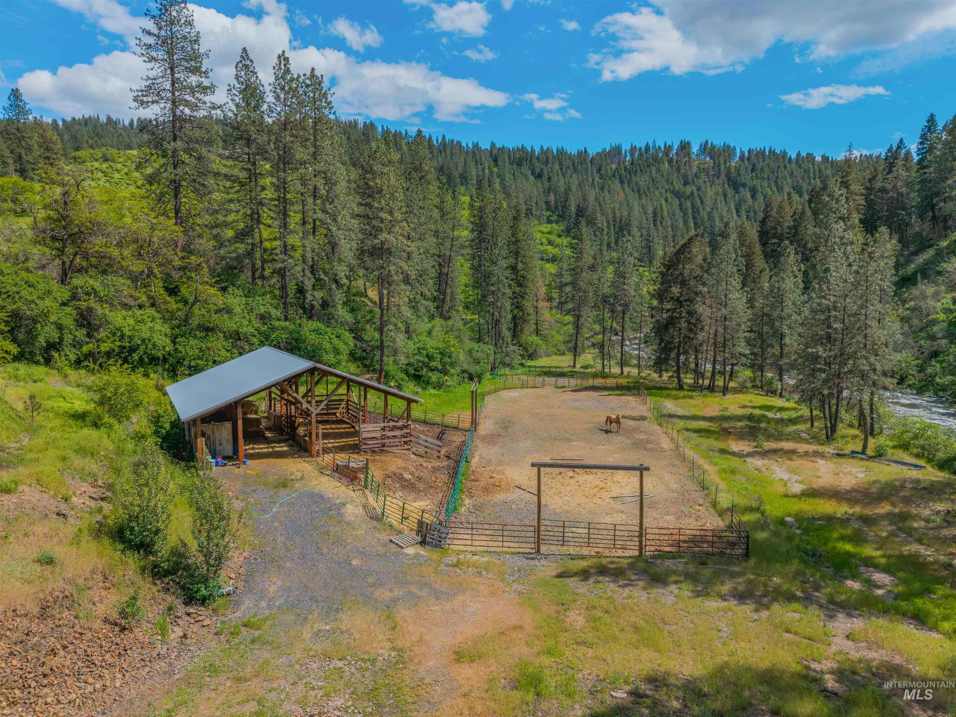 1314 Cedar Ridge Road Kendrick, ID 83537 - Photo 46 of 50 Equestrian facility featuring a covered barn structure, multiple fenced corrals, and a gated entry