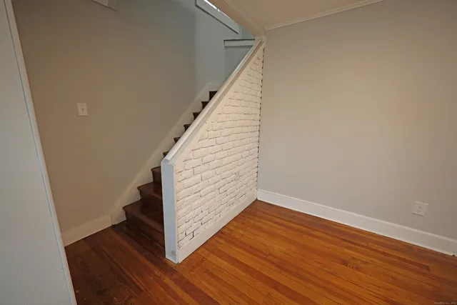 a view of an entryway with wooden floor