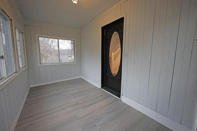 a view of a livingroom with wooden floor and window