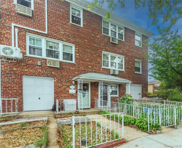 front view of a brick house with a large windows