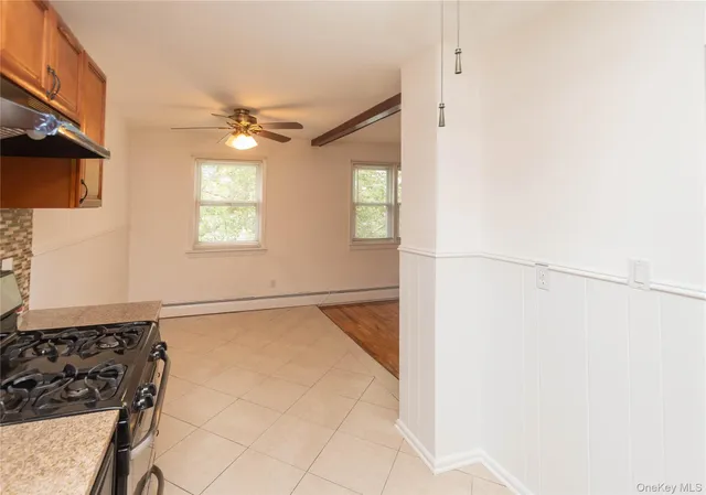 a view of a livingroom with wooden floor and a window