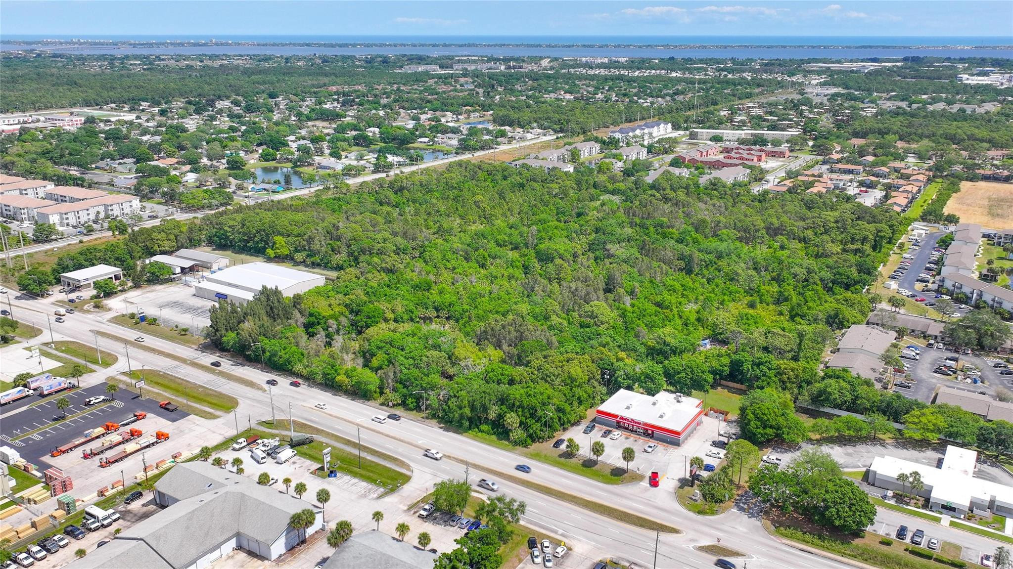 4527 South Babcock Street Palm Bay, FL 32905 - Photo 8 of 16 an aerial view of residential houses with outdoor space and trees