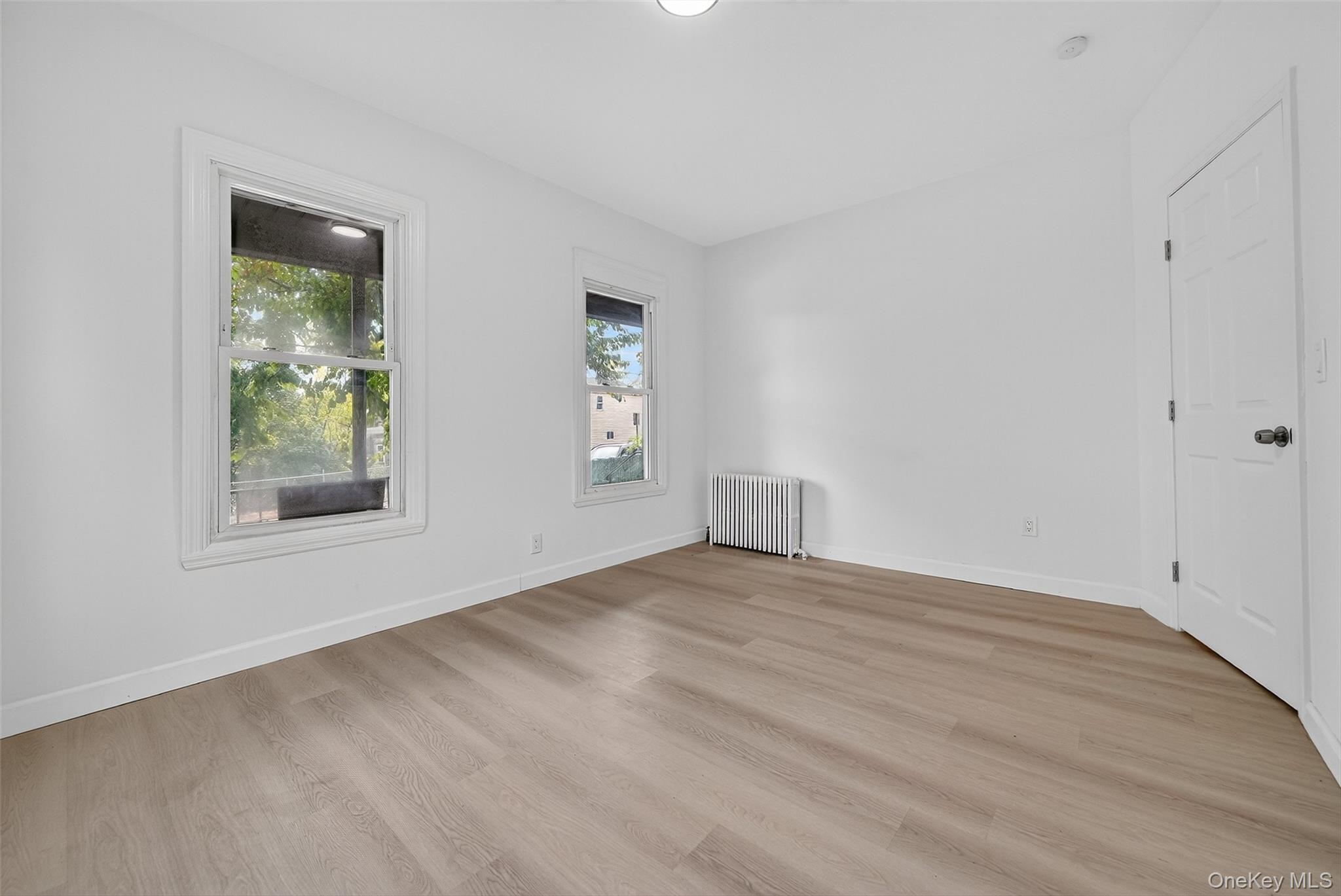 23 Ann Street, Unit 1 Ossining, NY 10562 - Photo 12 of 30 a view of an empty room with wooden floor and a window