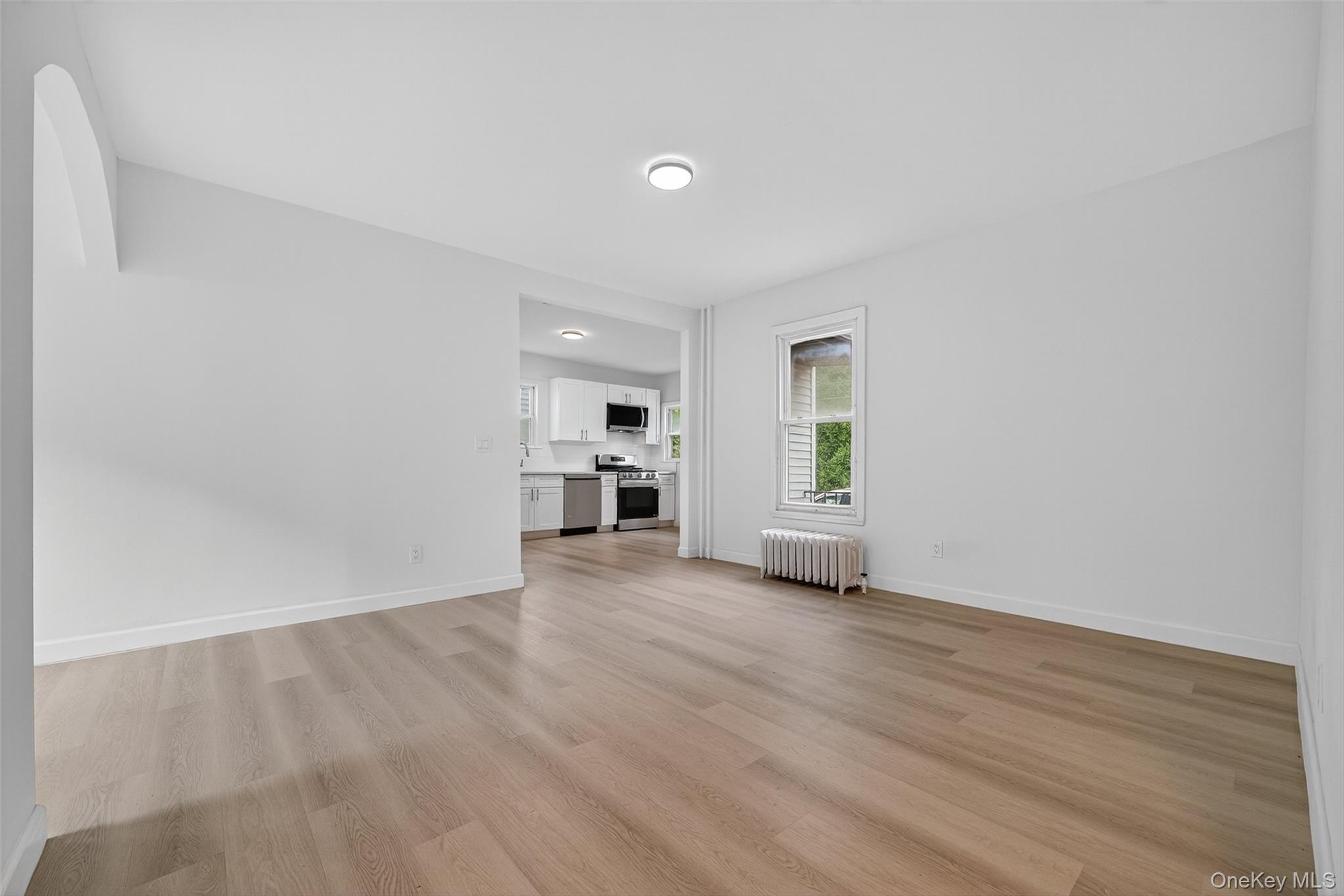 23 Ann Street, Unit 1 Ossining, NY 10562 - Photo 13 of 30 an empty room with wooden floor and windows