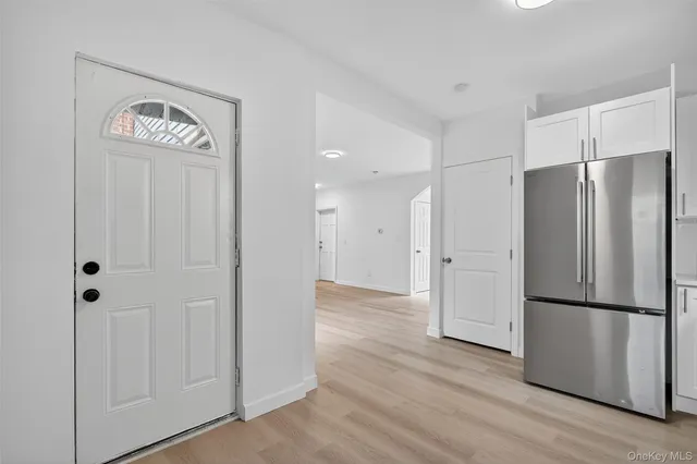 a view of a refrigerator in kitchen and wooden floor