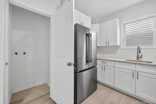 a kitchen with cabinets and stainless steel appliances