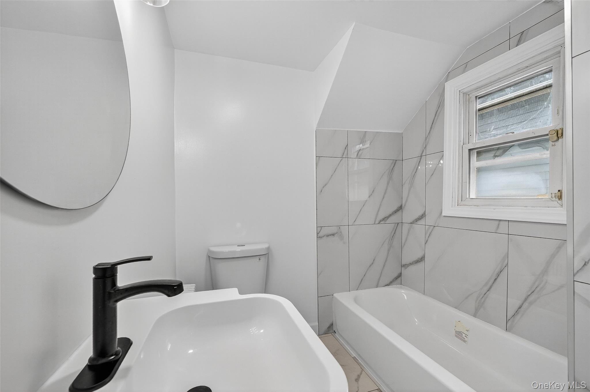 23 Ann Street, Unit 1 Ossining, NY 10562 - Photo 27 of 30 a bathroom with a sink and a bathtub