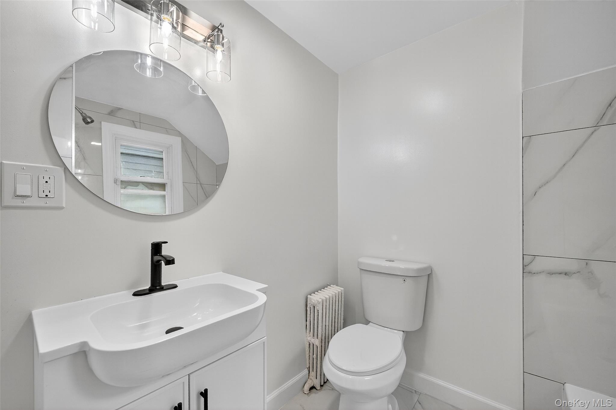 23 Ann Street, Unit 1 Ossining, NY 10562 - Photo 28 of 30 a bathroom with a toilet a sink and a mirror