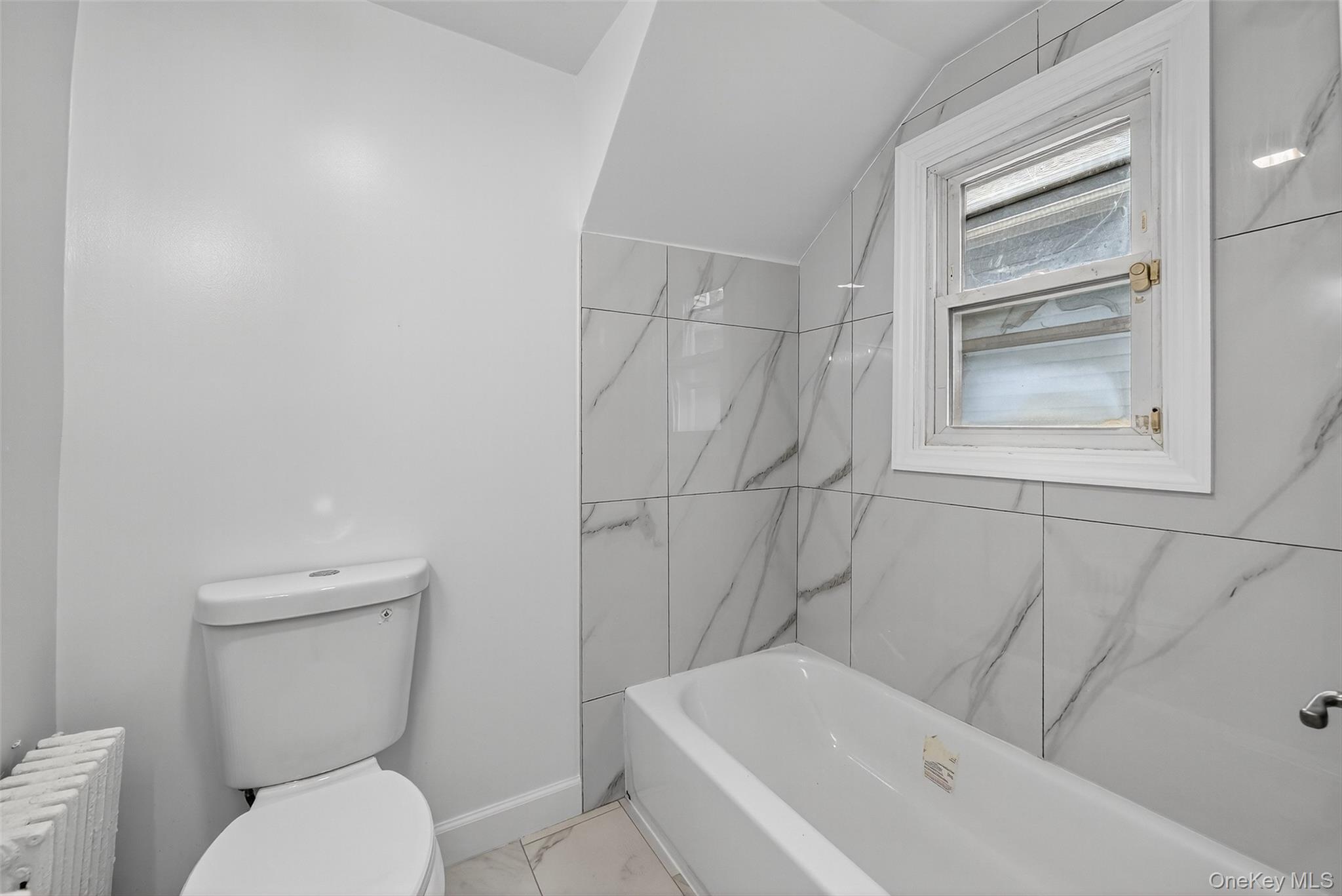 23 Ann Street, Unit 1 Ossining, NY 10562 - Photo 29 of 30 a bathroom with a toilet and bathtub