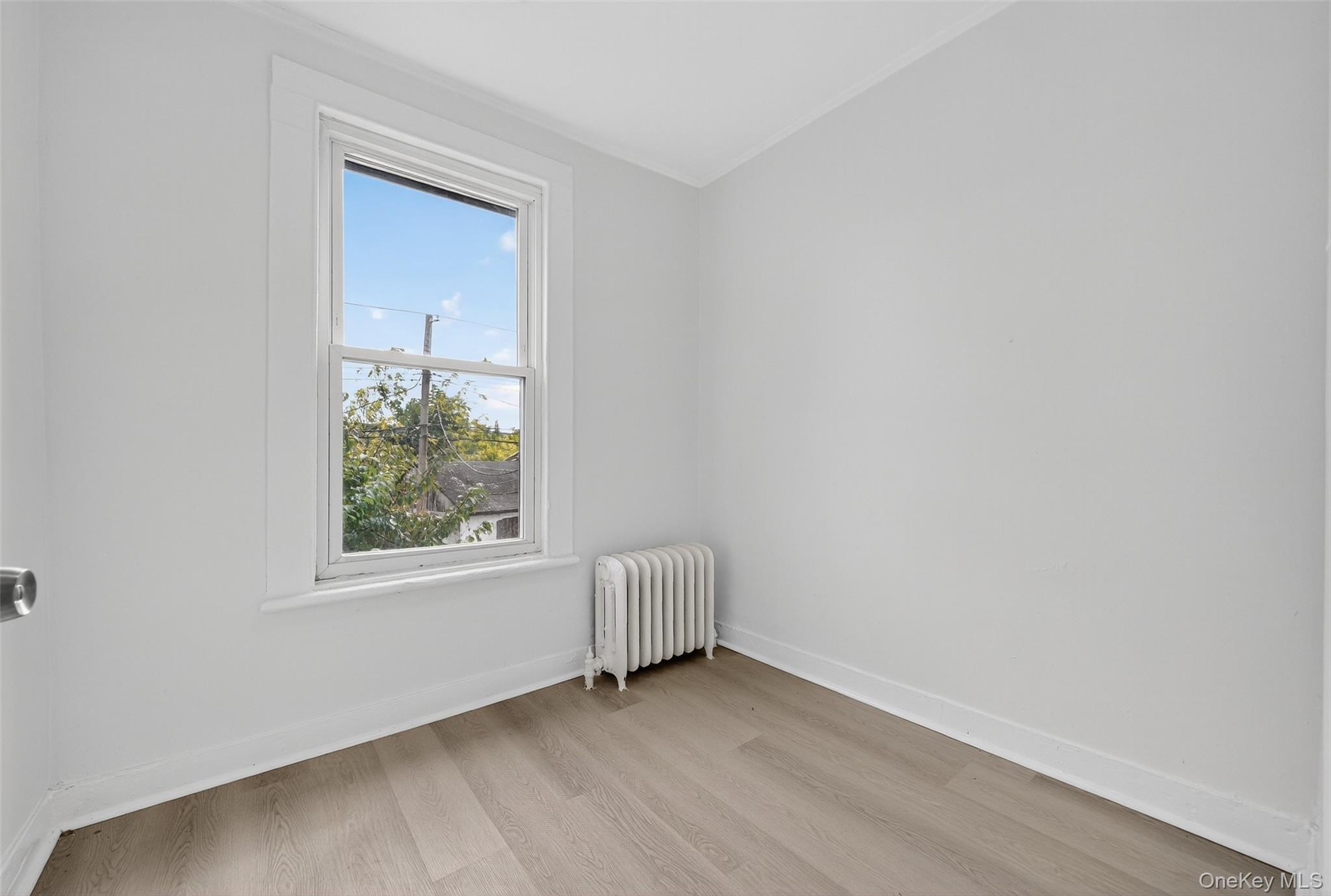 23 Ann Street, Unit 1 Ossining, NY 10562 - Photo 30 of 30 an empty room with wooden floor and windows