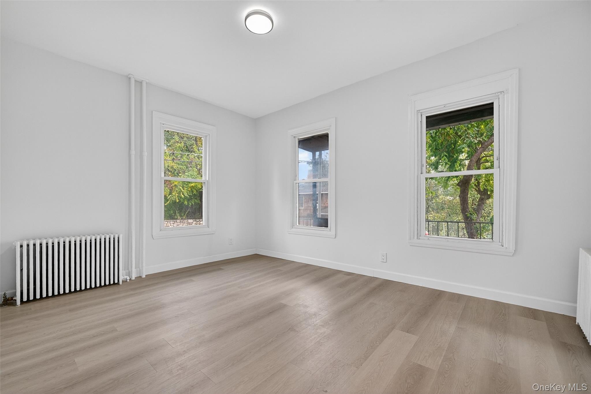 23 Ann Street, Unit 1 Ossining, NY 10562 - Photo 10 of 30 an empty room with wooden floor and windows