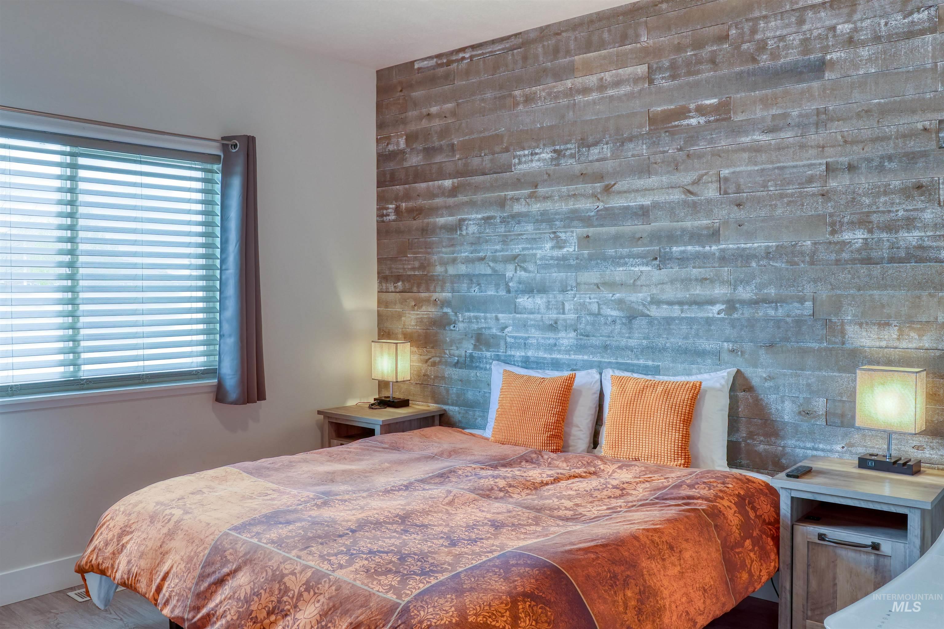 1087 Easy Avenue Twin Falls, ID 83301 - Photo 10 of 25 Bedroom with an accent wall and wood finished floors