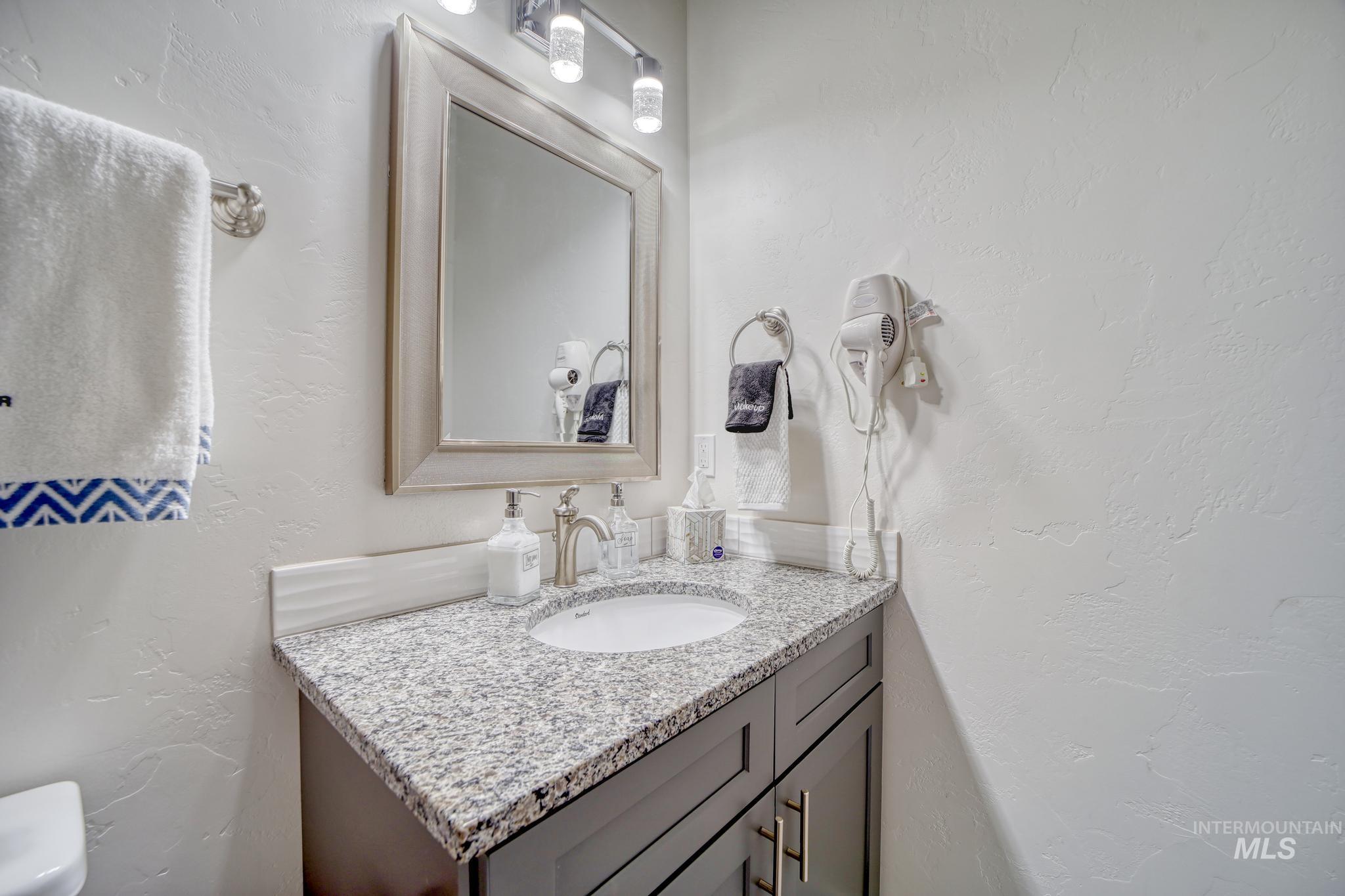 1087 Easy Avenue Twin Falls, ID 83301 - Photo 16 of 25 Half bathroom with a textured wall and vanity