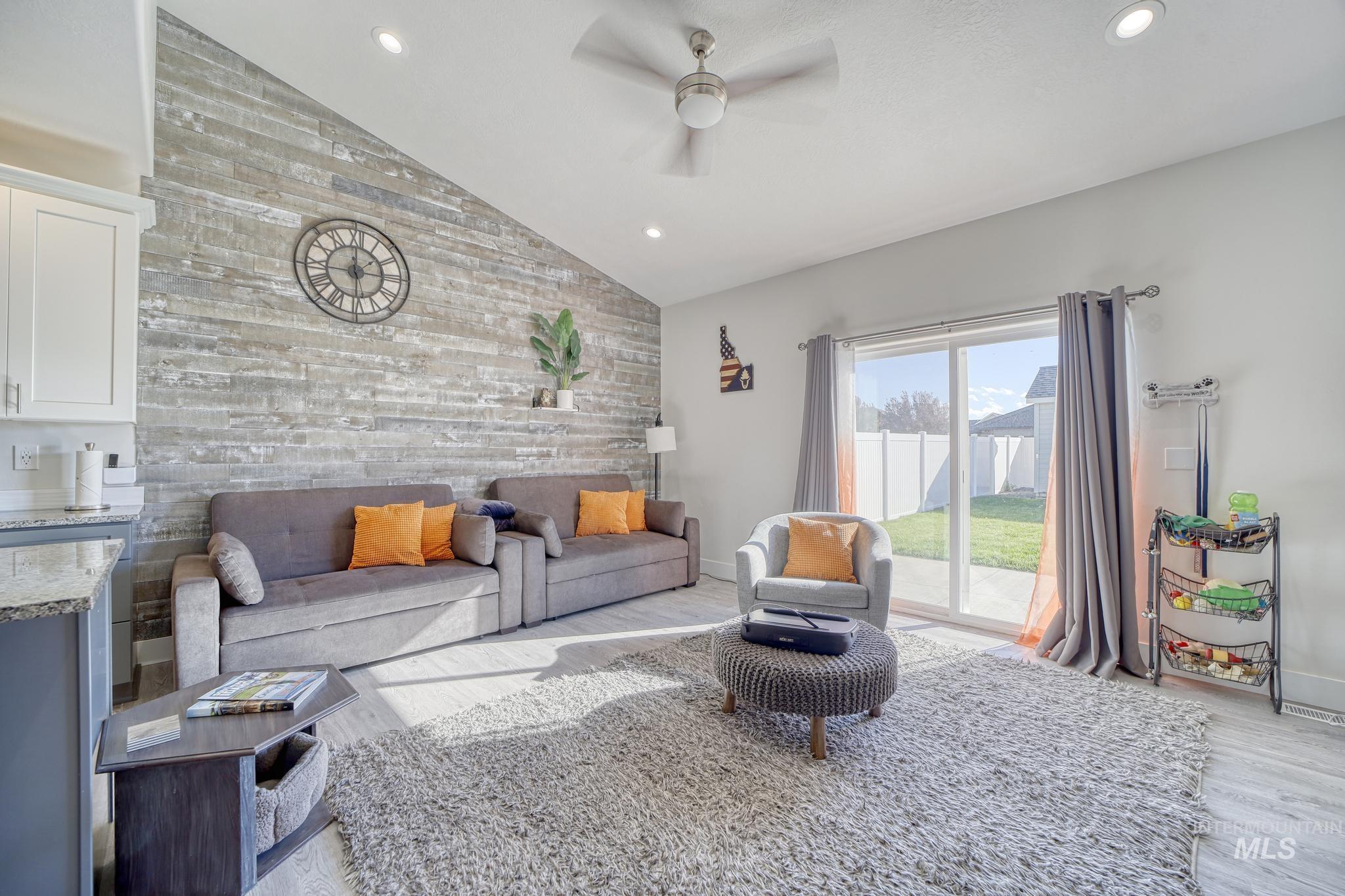 1087 Easy Avenue Twin Falls, ID 83301 - Photo 3 of 25 Living area featuring vaulted ceiling, recessed lighting, an accent wall, ceiling fan, and light wood-type flooring