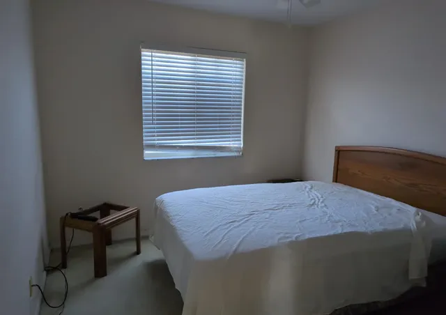 a bedroom with a bed and window
