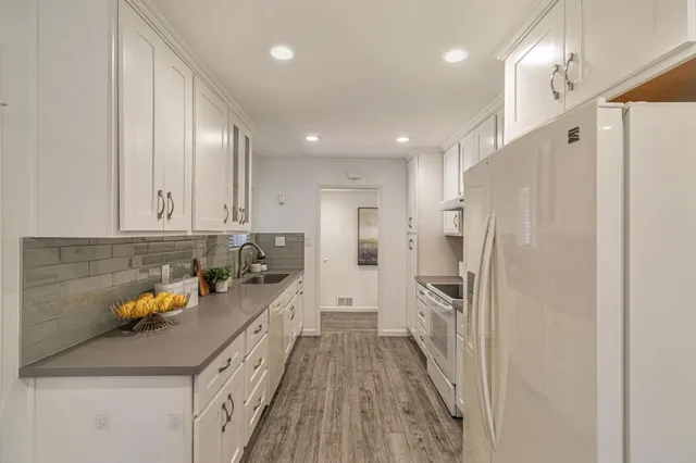 a kitchen with a sink and refrigerator