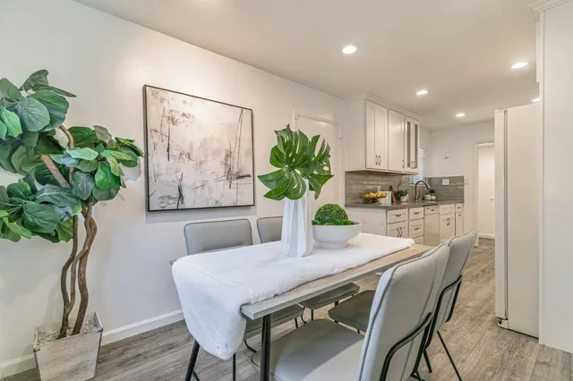 a dining room with furniture and wooden floor