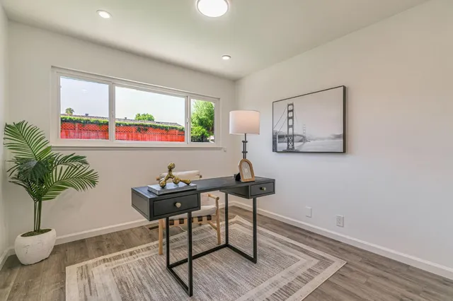 a living room with furniture and a potted plant