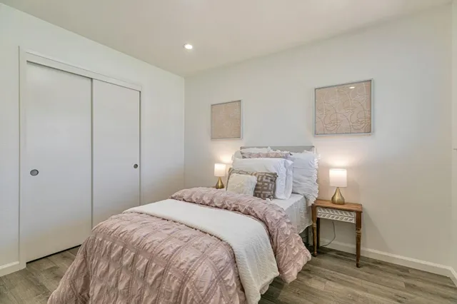 a bedroom with a bed and a night stand