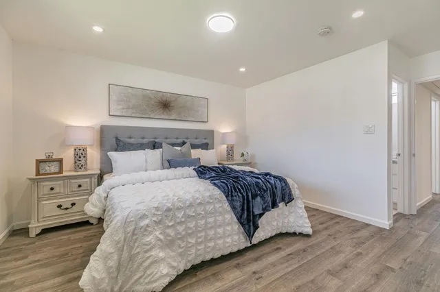 a bedroom with a bed and a painting