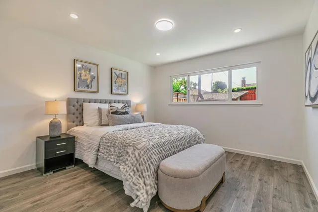 a bedroom with a bed and a couch