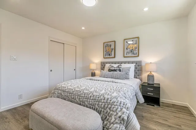 a bedroom with a bed and a painting