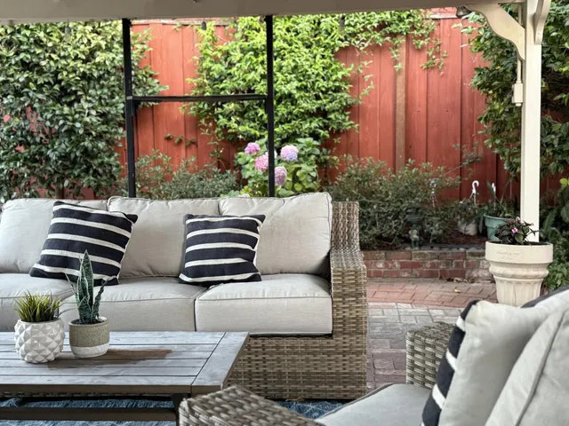 a balcony with furniture and flowers