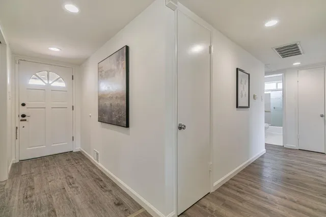 a view of hallway with wooden floor