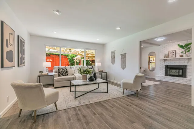 a living room with fireplace furniture and a wooden floor
