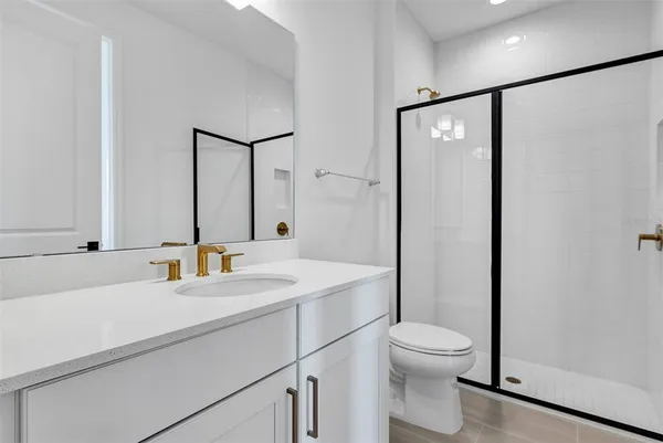 a kitchen with stainless steel appliances a stove a sink and white cabinets