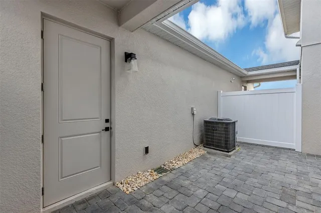 a large kitchen with kitchen island a large counter space a large window and stainless steel appliances