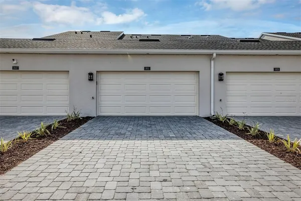a large white kitchen with a table and chairs