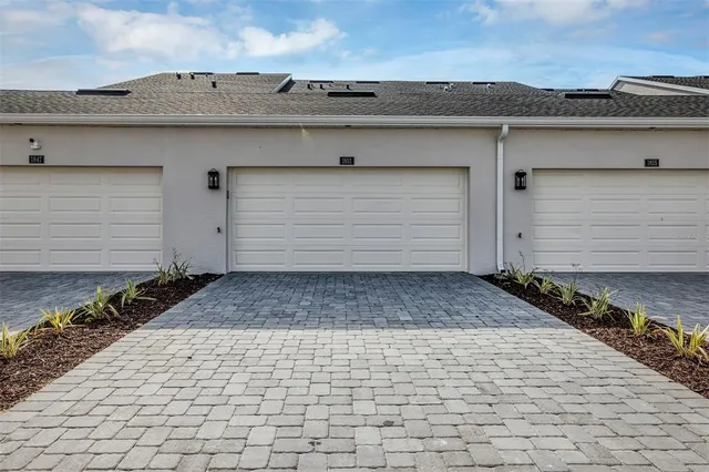 a large white kitchen with a table and chairs