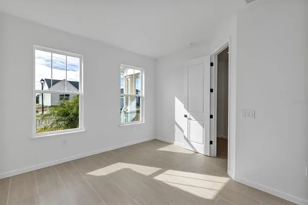 a kitchen with stainless steel appliances granite countertop a refrigerator a sink dishwasher a stove and white cabinets with wooden floor
