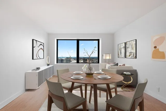 a view of a dining room with furniture and a window