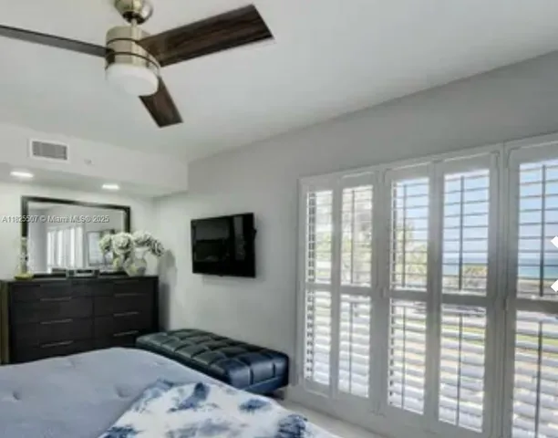 a bathroom with a granite countertop sink a mirror and shower