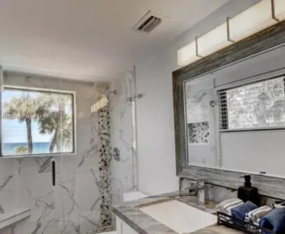 a bathroom with a shower curtain and window