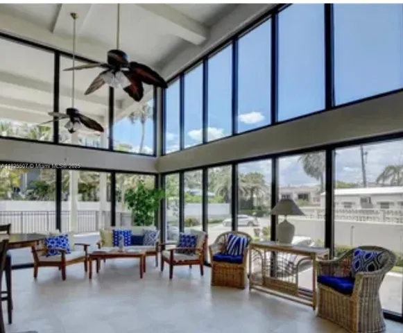a living room with furniture a mirror and a large window