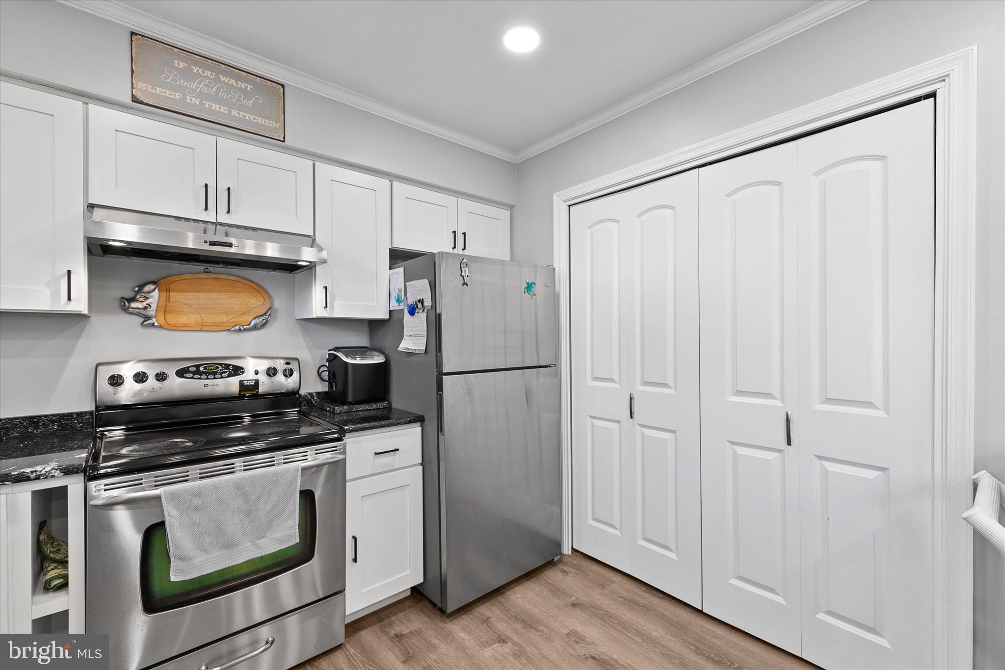 37239 Main Street Ocean View, DE 19970 - Photo 12 of 43 a kitchen with white cabinets and stainless steel appliances