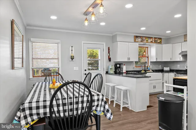 a large kitchen with a large window and stainless steel appliances