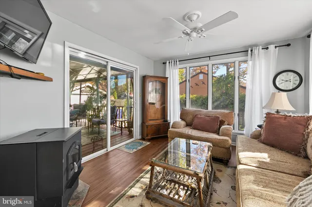 a living room with furniture a large window and a clock