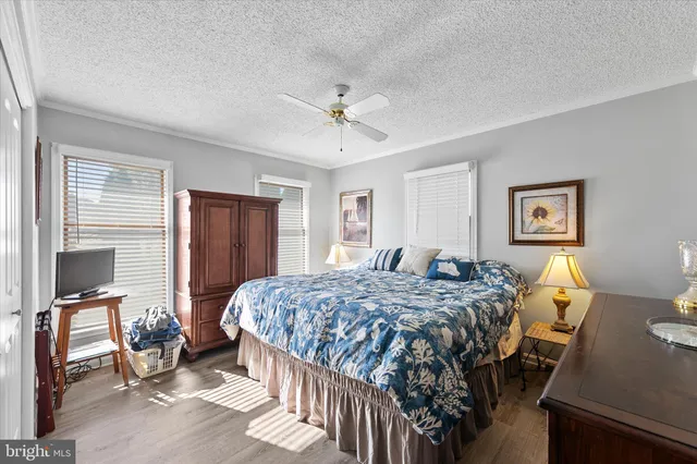 a bedroom with a bed and dresser with mirror